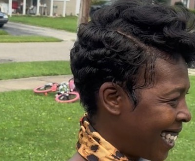 A client smiling after having her hair styled